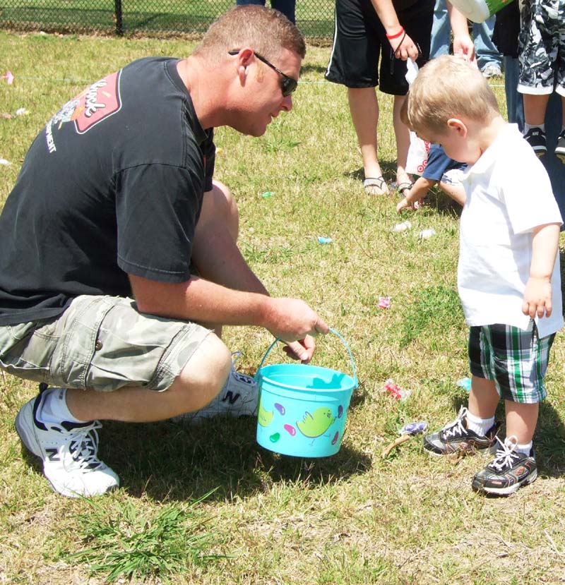 photo of boy and dad hunting for eggs